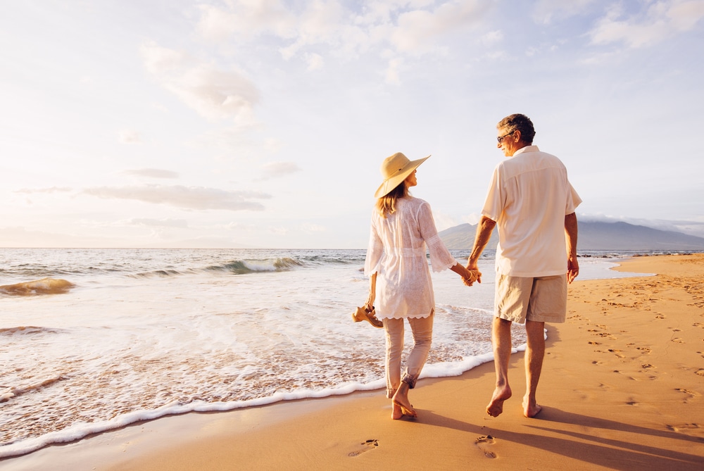 Couple walking on the beach, representing healthy aging and hormone wellness